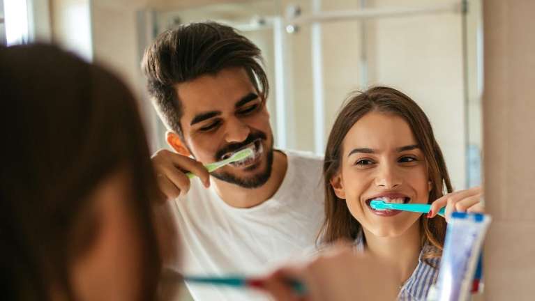 young couple brushing their teeth in doreen