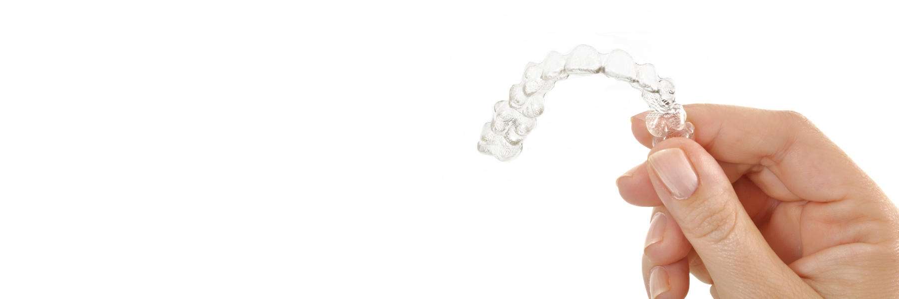 patient holding clear aligners in Doreen